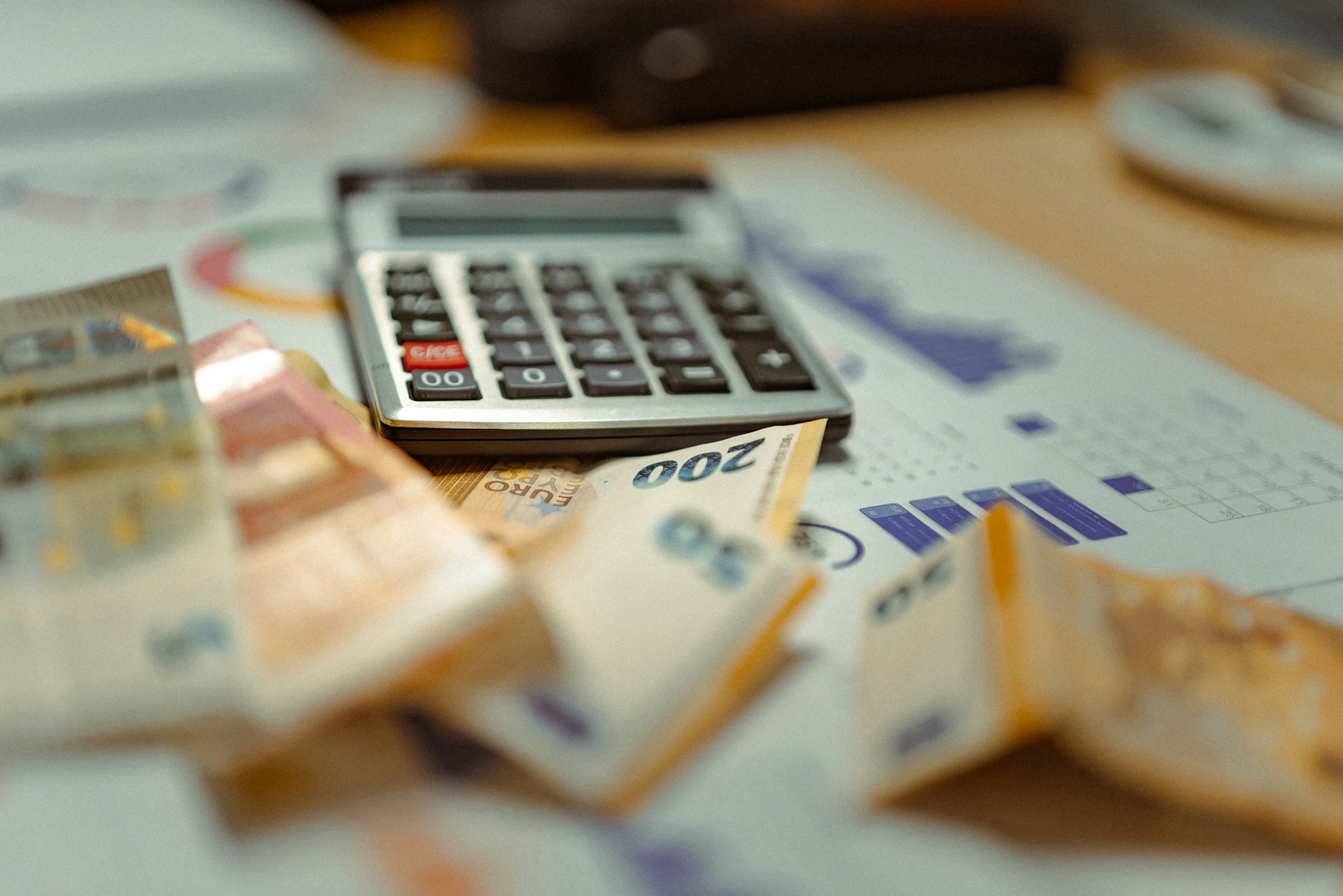 Calculator on top of currency stack - Essential Management Consultancy UAE